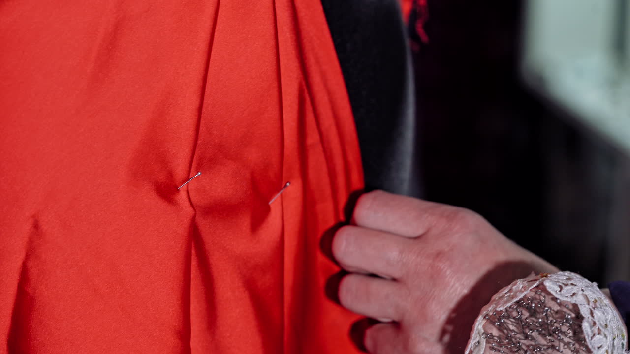 Girl working with sewing pattern. Woman fashion designer measuring on mannequin