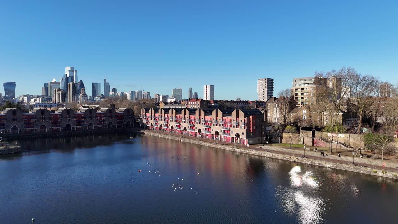 Riverside apartments Shadwell Basin East London UK city skyline in background 2025 drone,aerial