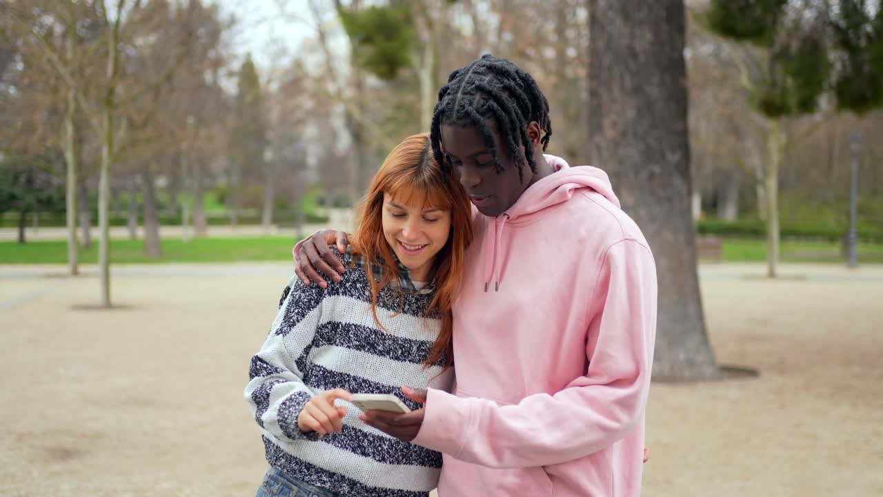 Couple using a smartphone in a park