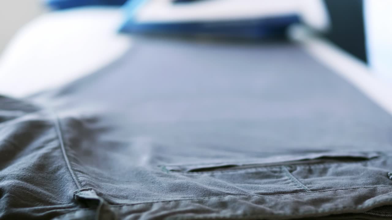 Selective focus of women is ironing clothes and pants to use them throughout the week of work daily routine and holidays