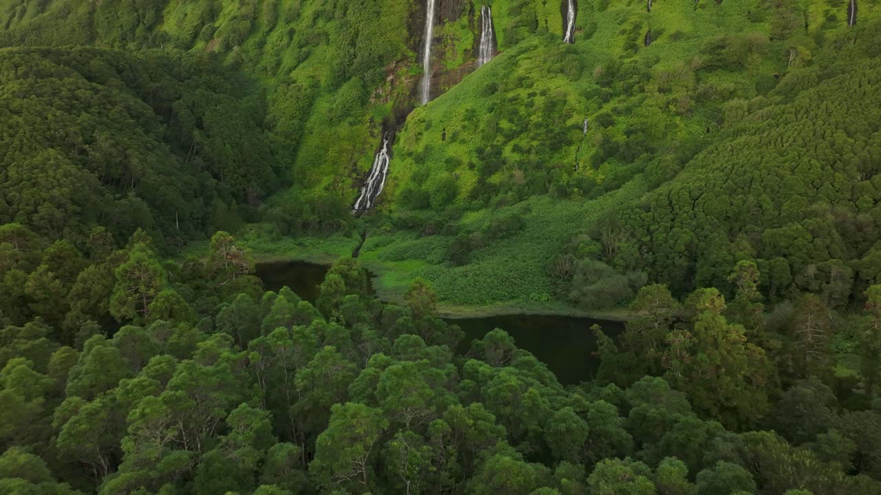 Wide view of waterfall Po&ccedil;o Ribeira do Ferreiro in Flores island - Drone shot