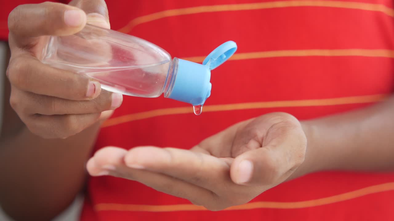 niño aplicando desinfectante para manos