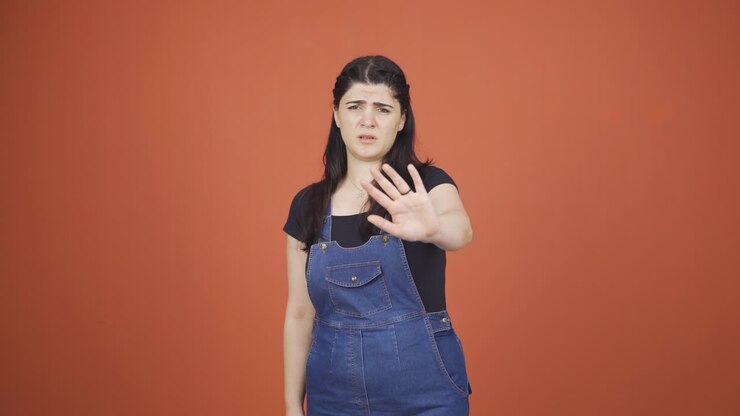 Fear reaction of woman looking at camera. Coward woman.