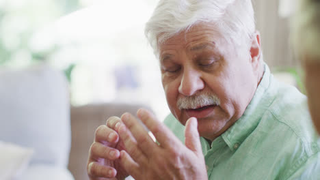 Senior-caucasian-man-talking-to-friend-in-living-room,-slow-motion