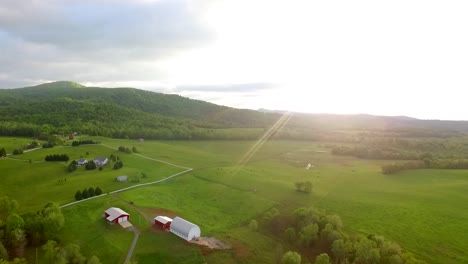 Flying-towards-golden-dawn-over-lush-green-hills-in-the-Shenandoah-Valley,-part-of-the-Blue-Ridge-Mountain-chain-on-the-East-Coast-United-States