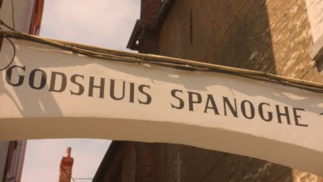 Shot-of-Godshuis-Spanoghe-entrance-sign-in-West-Flanders,-Bruges,-Belgium_4K