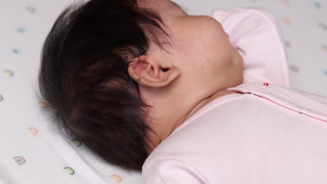 adorable baby girl sleeping peacefully in crib