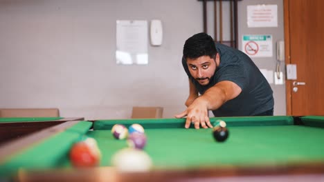 young man playing billiard snooker player missing the shot