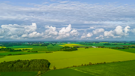 green field and picturesque clouds in the sky. timelapse