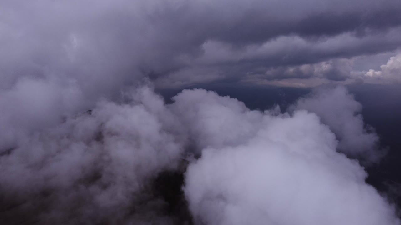 Dark scene of a drone flying through the clouds