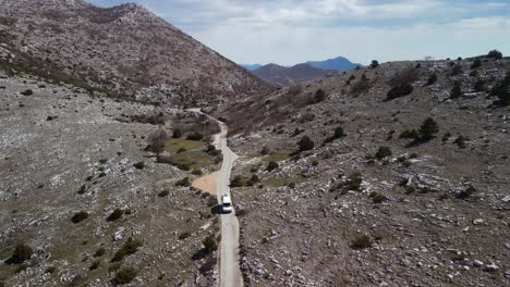 aerial, rv traveling alone down countryside road, park prirode biokovo