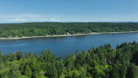 Drone-shot-of-Herron-Island-across-the-water-from-Lakebay,-Washington