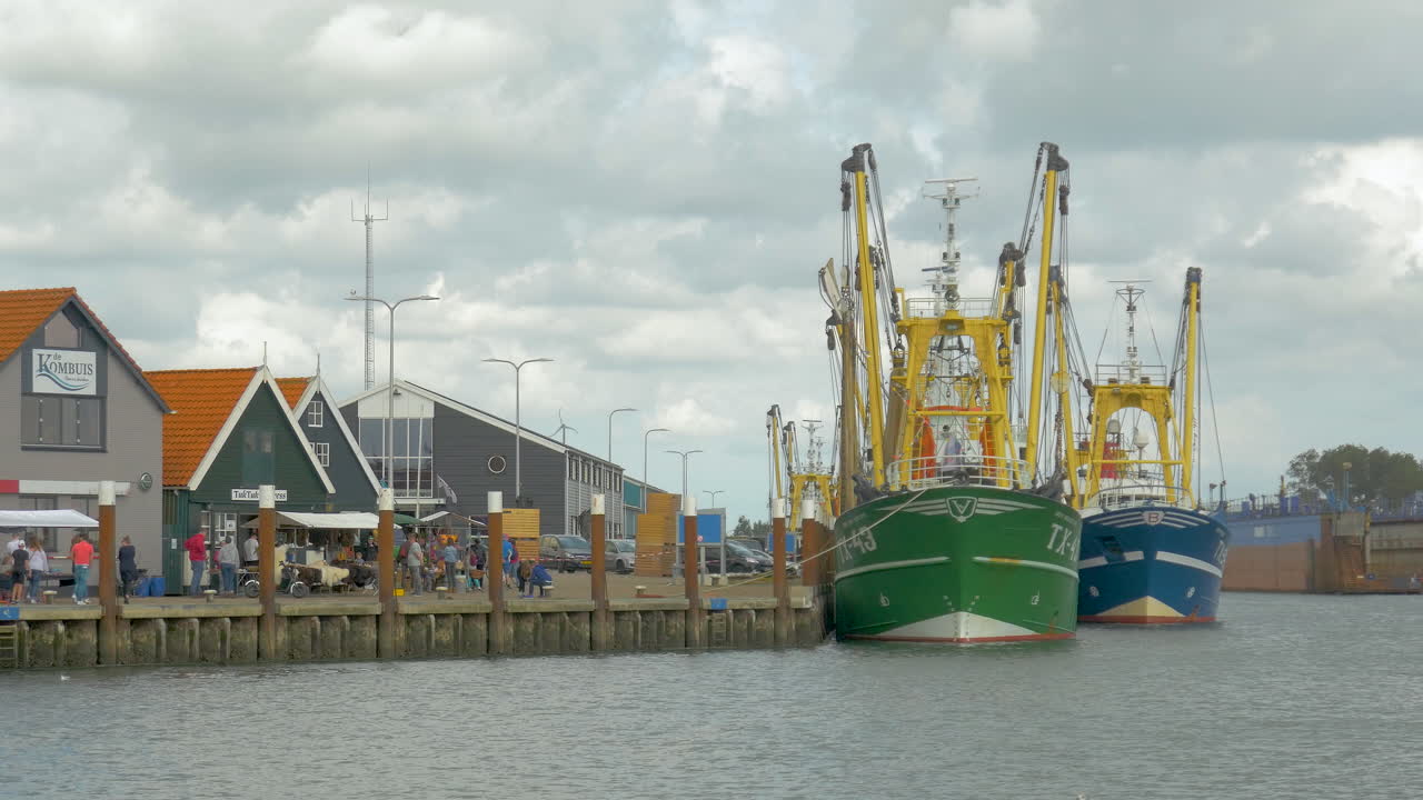 Fishing Boats Docked at a Harbor on a Cloudy Day