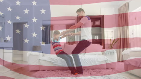 animation of flag of usa waving happy caucasian father and son playing in living room
