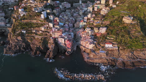 colorful coastal town of riomaggiore, cinque terre, shot from above at sunset