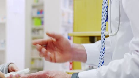 Pharmacist-explaining-prescriptions-to-customer