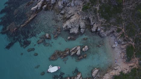 Yachts-anchored-off-the-coast-of-small-rocky-beach-in-Europe