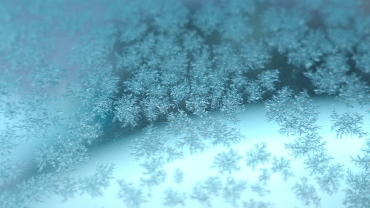 Frosty Patterns And Snowflakes On Glass Surface. Close up