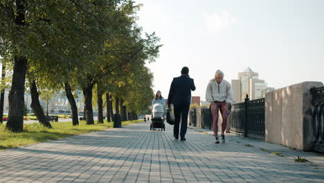 city park scene with people and baby stroller