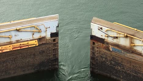 close-up of the hydraulic gates of gatun locks chamber slowly opening, panama canal