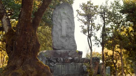 Slide-shot-of-big-stone-with-carving-on-it-outside-a-temple-in-Kyoto,-Japan-4K-slow-motion