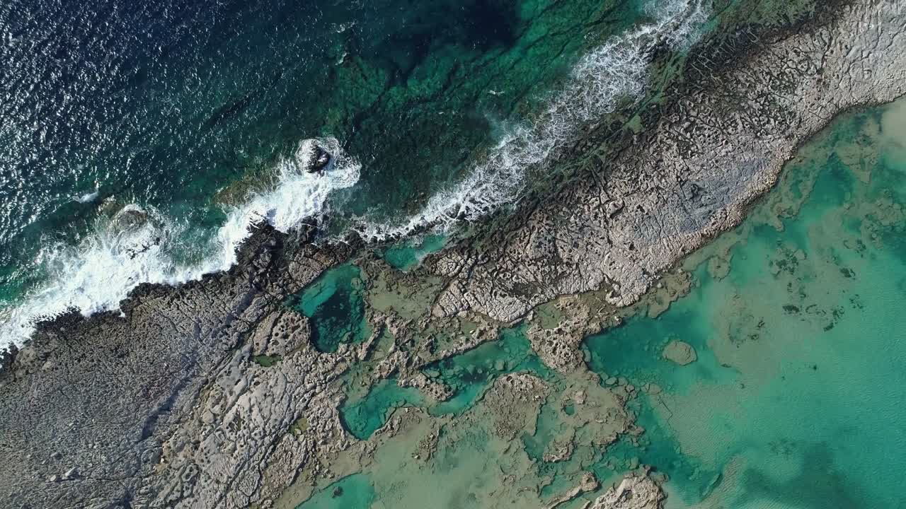 Landscape with sea waves, cliff and blue lagoon. Aerial shot, 4K UHD