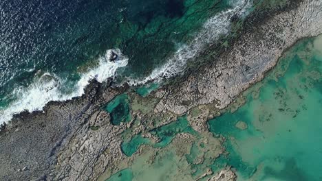 landscape with sea waves, cliff and blue lagoon. aerial shot, 4k uhd