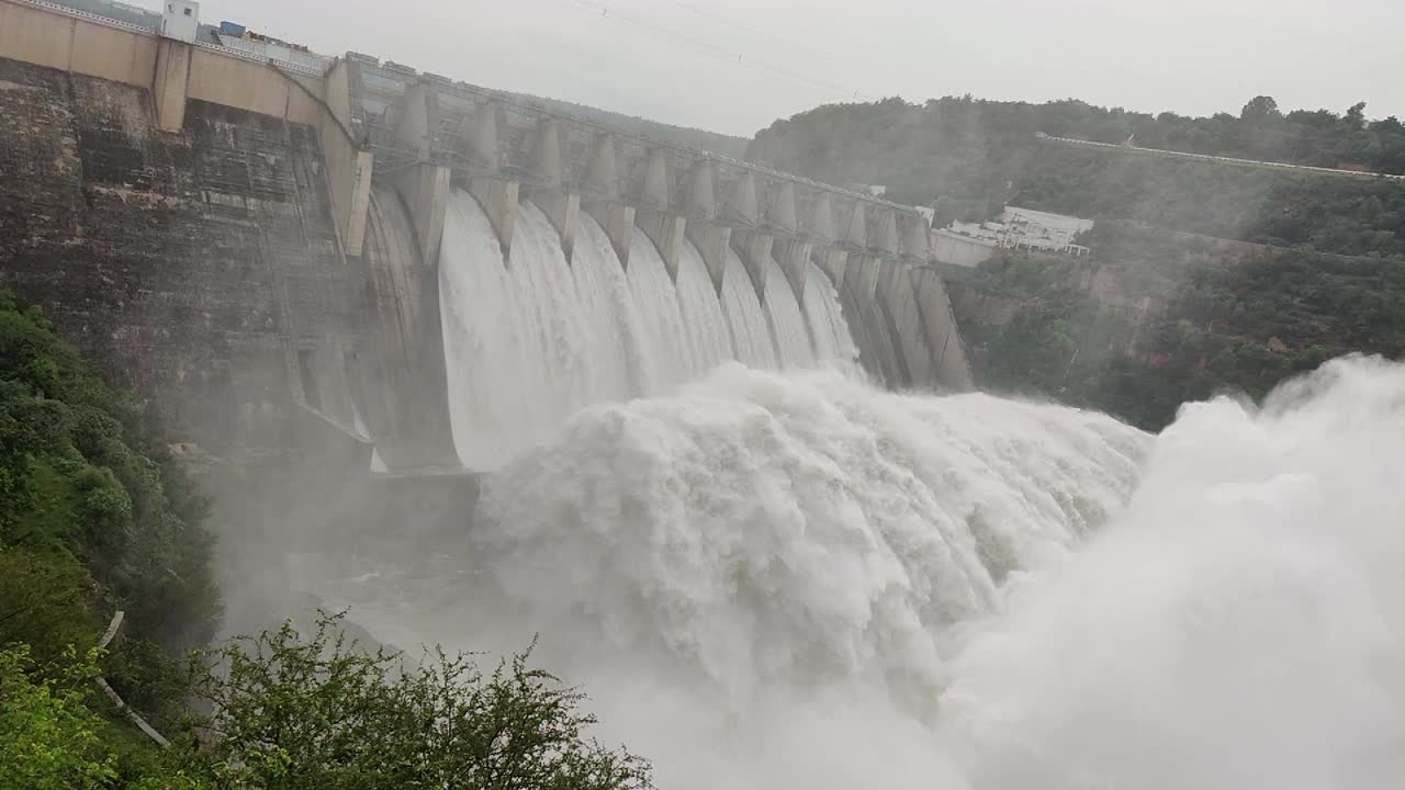 Hand Held shot of Srisailam Reservoir With Water Flowing in Ultra Slow Motion