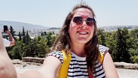 happy woman's selfie overlooking the city of athens, greece