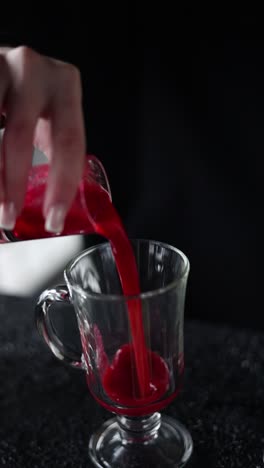 pouring a red cocktail