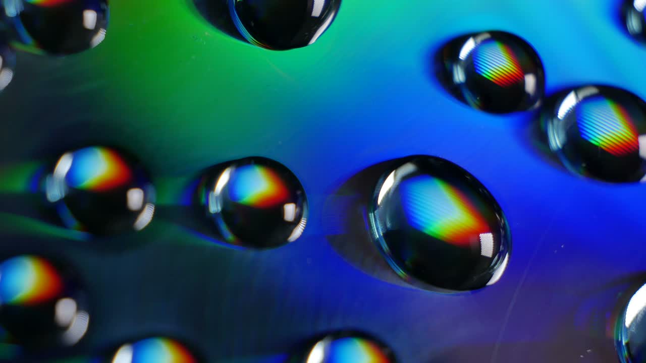 Wonderful world of physics. Interference and diffraction. Water drops close up with rainbow effect. White light is divided into components