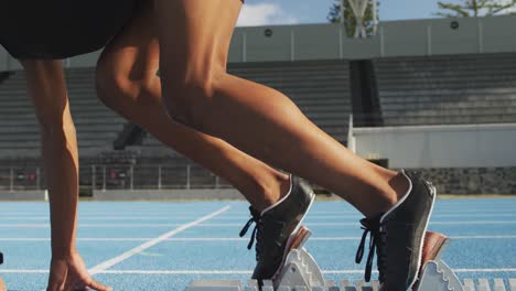 mixed race athlete preparing for race in stadium