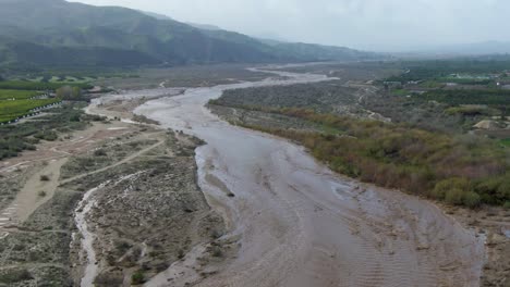 santa clara river after heavy rains, swollen and flooded