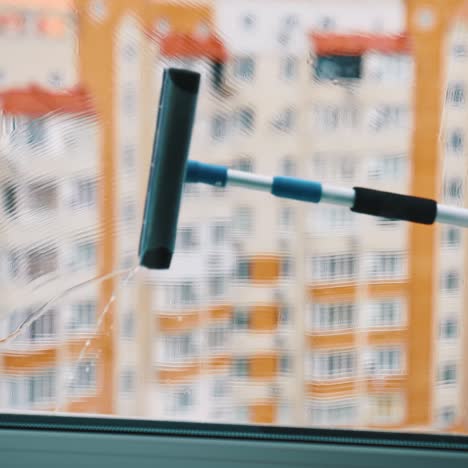 squeegee cleaning window glass
