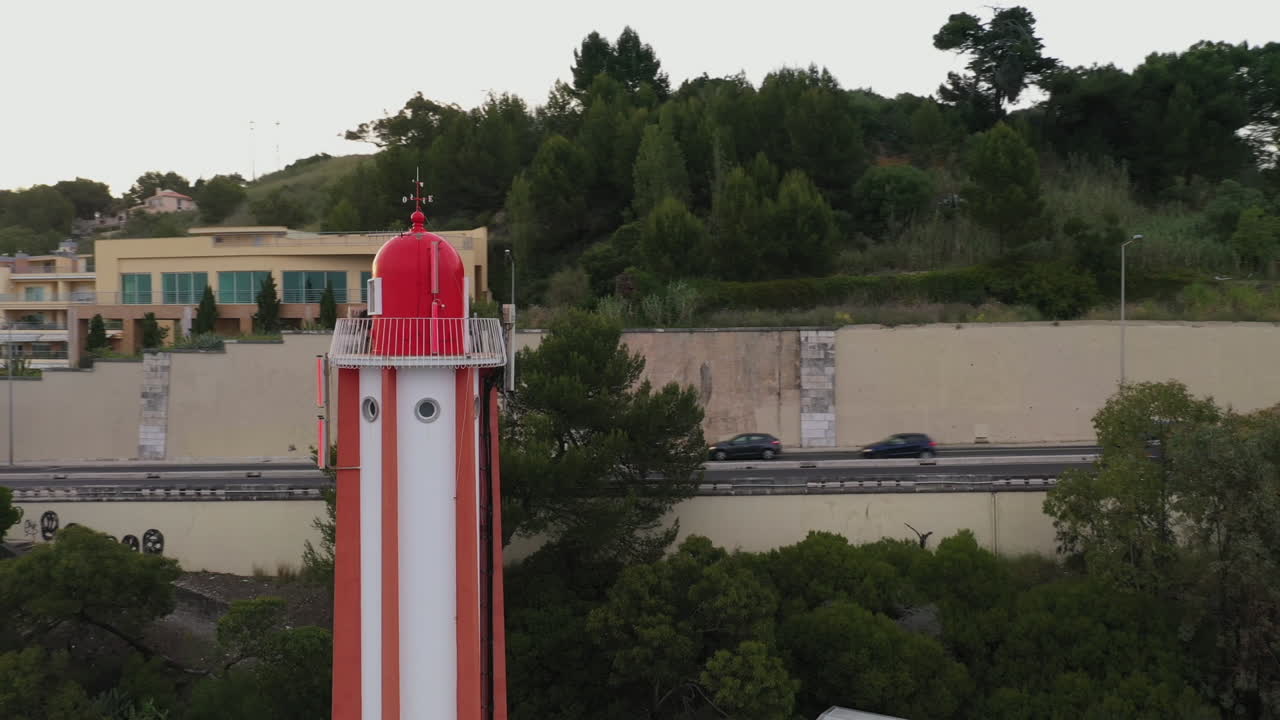 Aerial shot Orbiting over Red Lighthouse, Riverside Lisbon