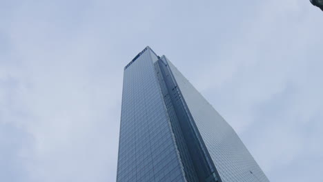 modern skyscraper against cloudy sky