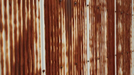 rusty corrugated metal wall with vertical patterns.