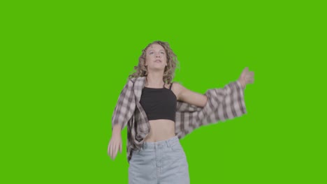 Studio-Shot-Of-Young-Woman-Having-Fun-Dancing-Against-Green-Screen-7