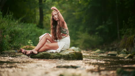 view of a woman meditating by the river