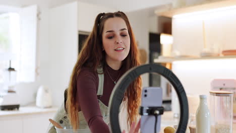 Woman,-phone-and-live-streaming-in-kitchen