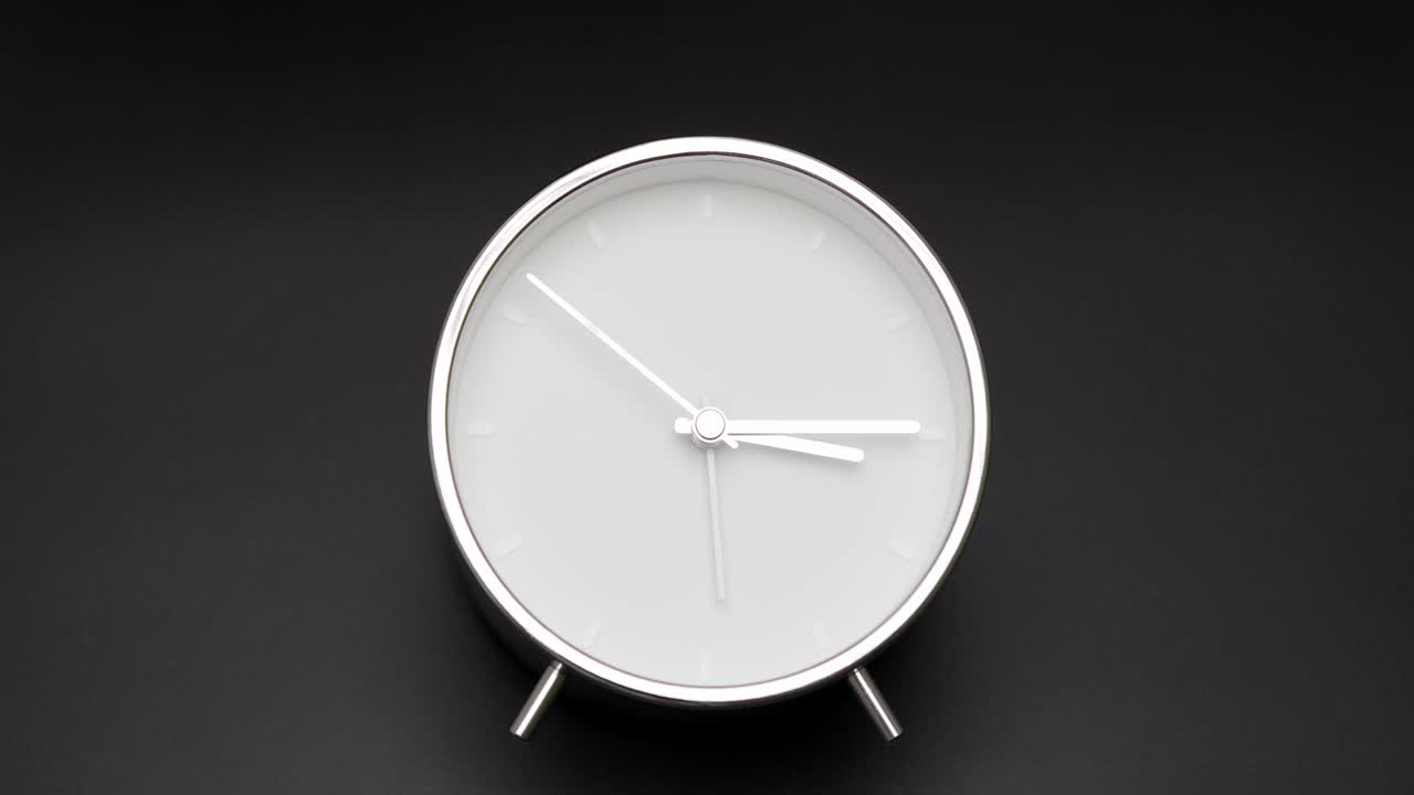 silver clock isolated on black background, Time starts walking at 3 o'clock.