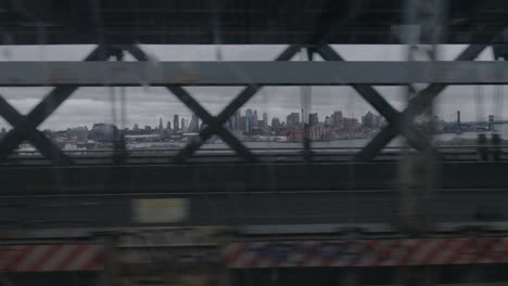 view of downtown brooklyn nyc from a moving subway car