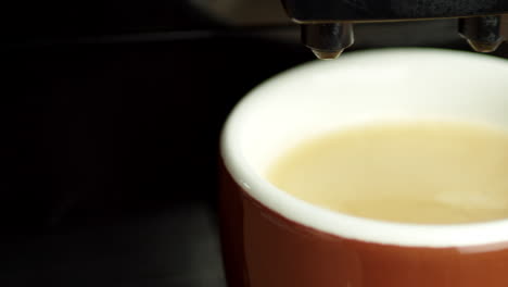 slow pan, filled coffee mug under fully automatic coffee machine