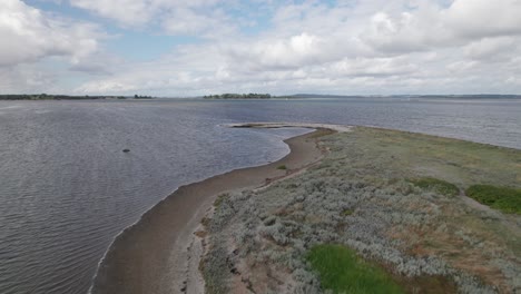 Flyover-Aerial-View-of-Point-and-the-Sea-with-a-Beautiful-Beach---Dolly-Shot