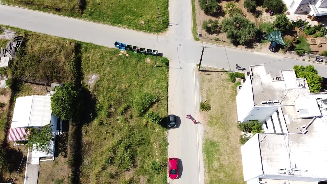 un día soleado sobre un pequeño pueblo de creta, un avión no tripulado se inclina hacia arriba