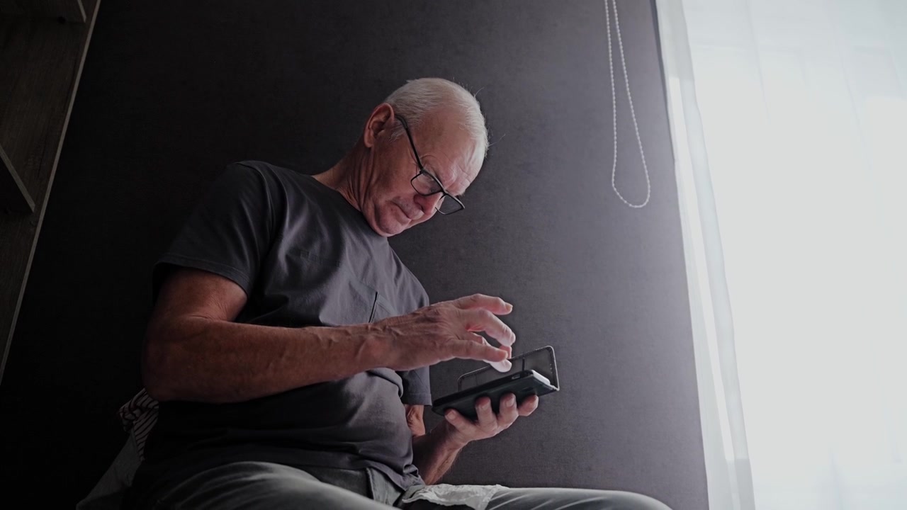 Older Adult Navigating Financial App on Smartphone in Cashless Economy Era