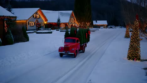 vintage truck carrying christmas trees on a snowy night