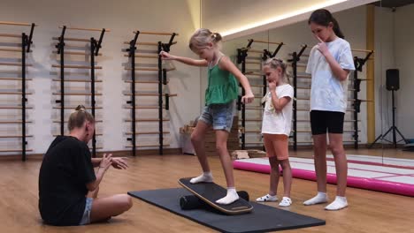 children practicing balance exercises in a gym