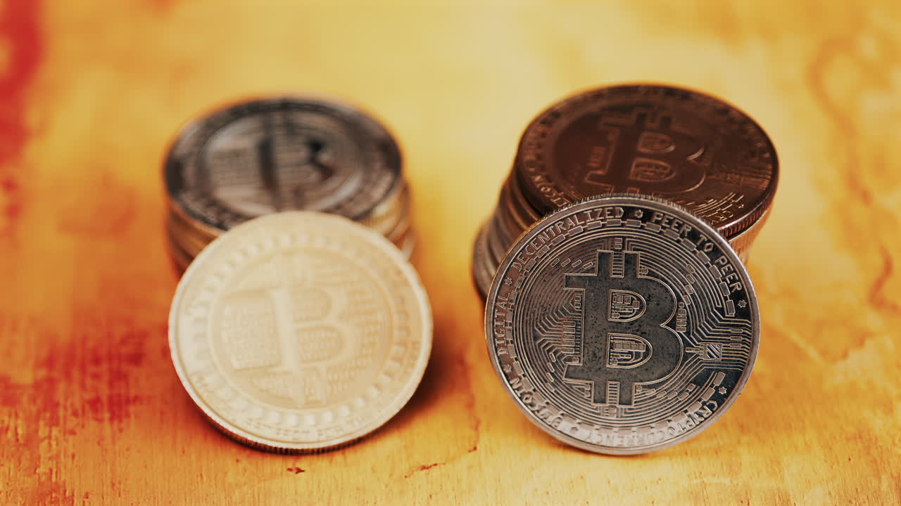 Close up of shiny physical Bitcoin coins stacked on a table