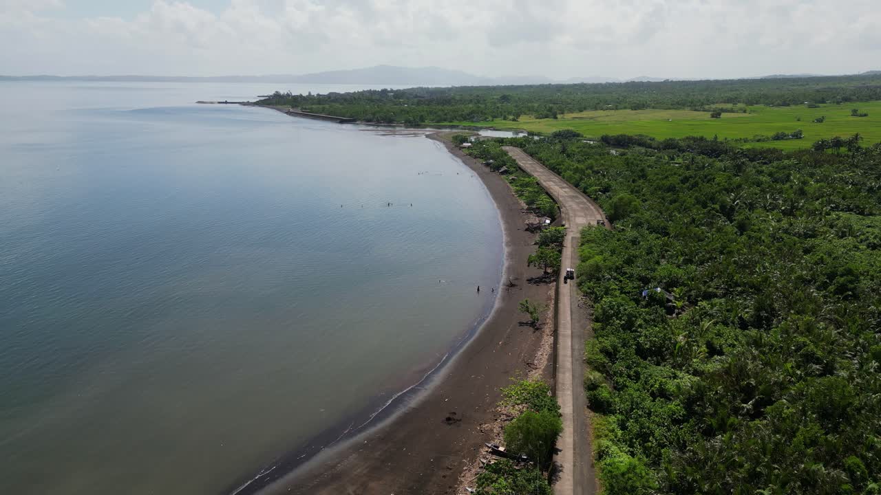 Panoramic aerial overview of calm ocean bay along Malilipot Seawall coastline at Albay, Philippines.